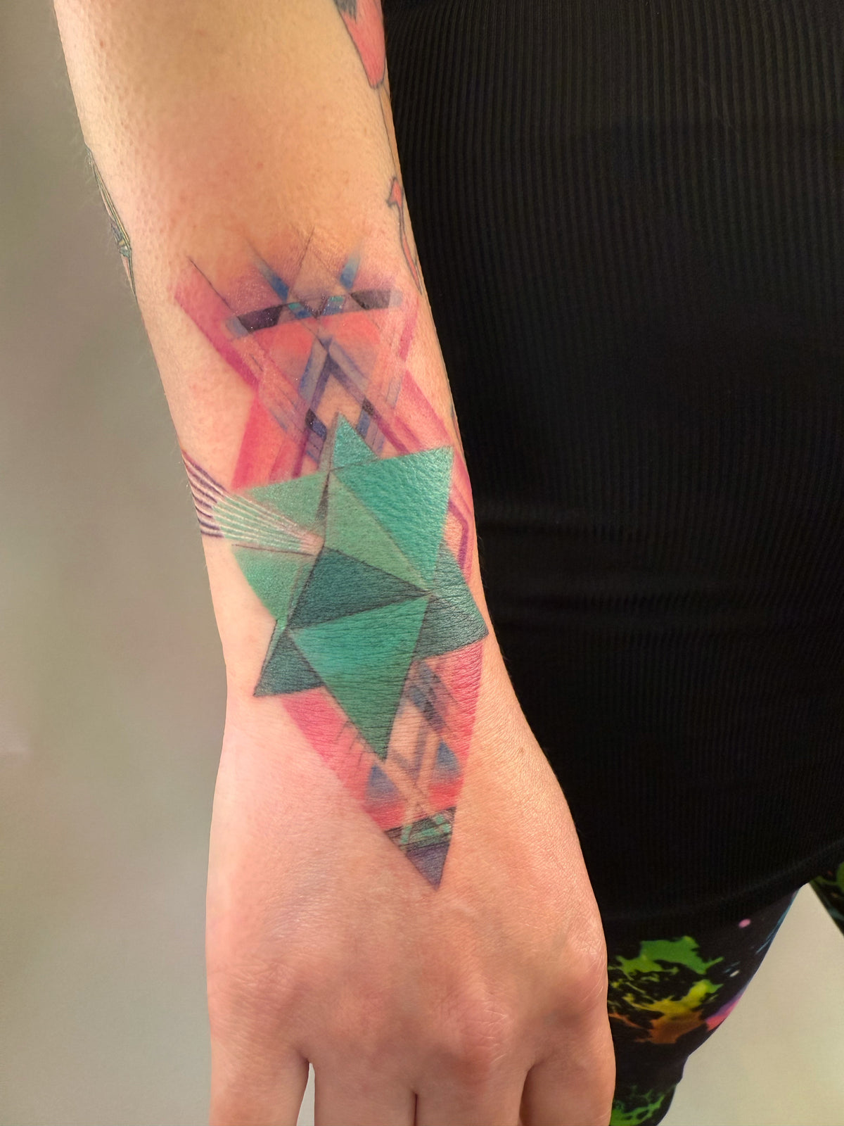 KB, "4th Dimensional Merkaba", Ink in skin, 7" x 6". 2025